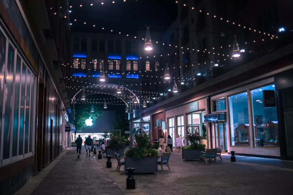 Nighttime view of pedestrianized street in Bethesda, maryland with benches and people walking